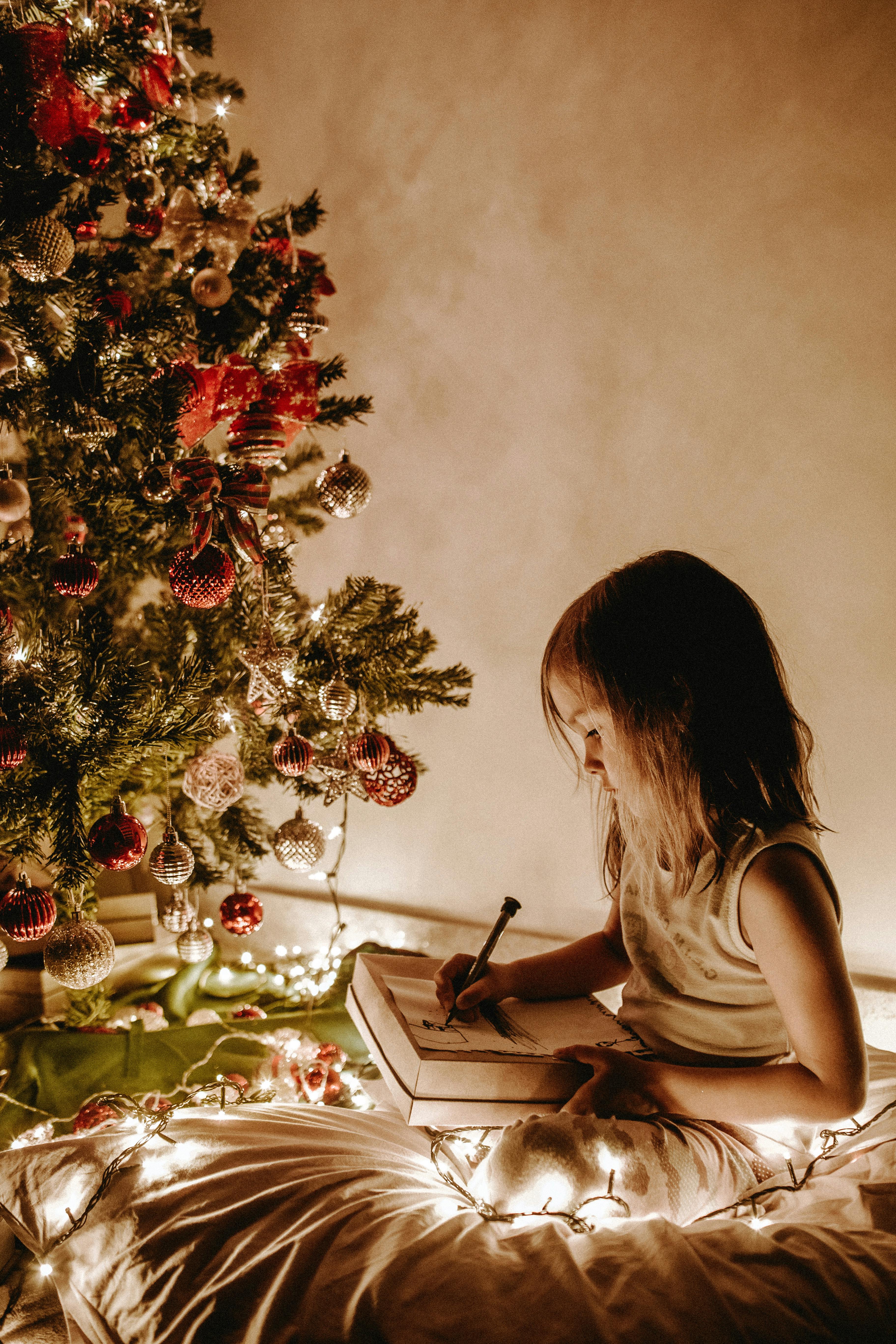 Child Drawing by Christmas Tree 
