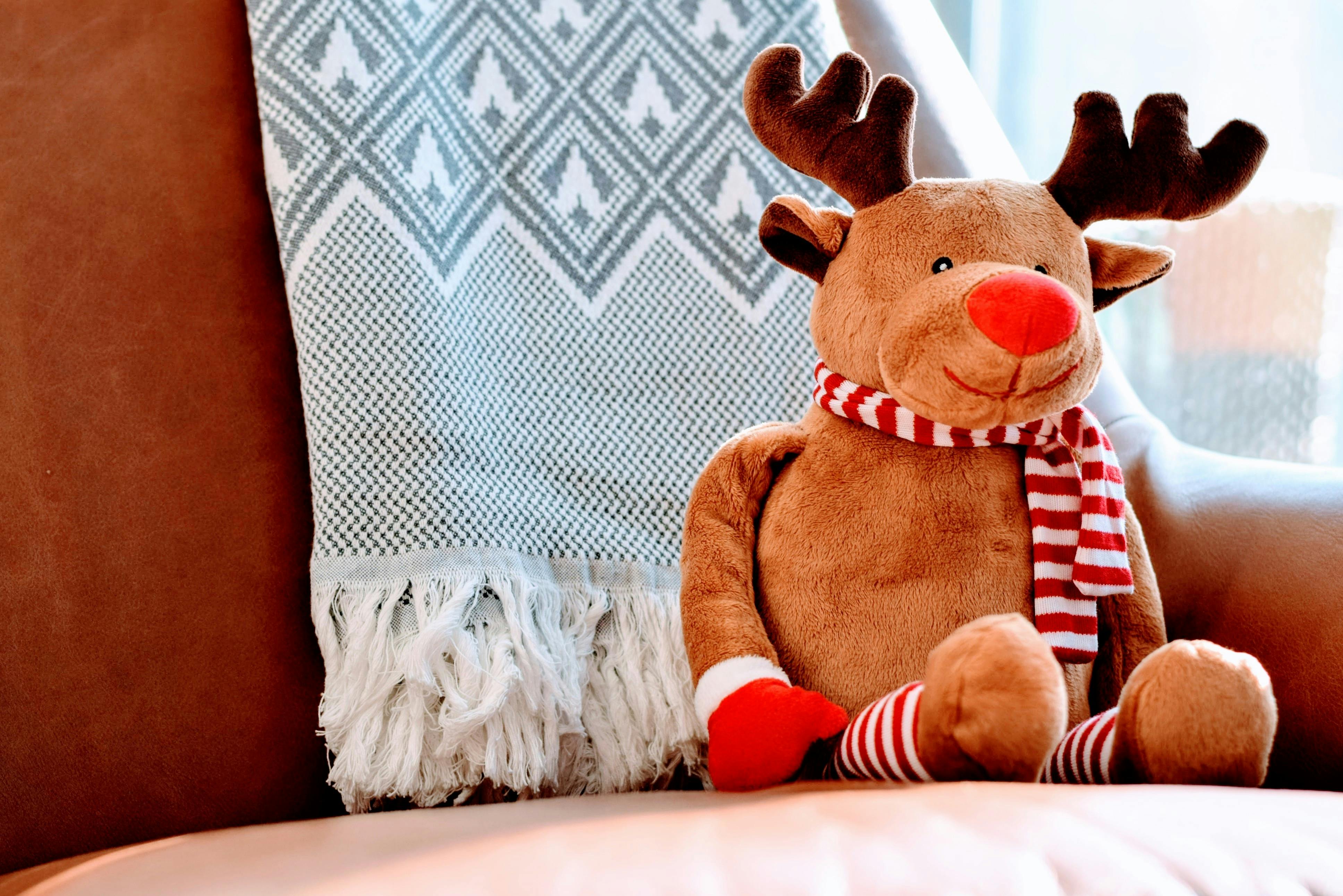 Cozy Christmas Reindeer Plush Toy on Armchair