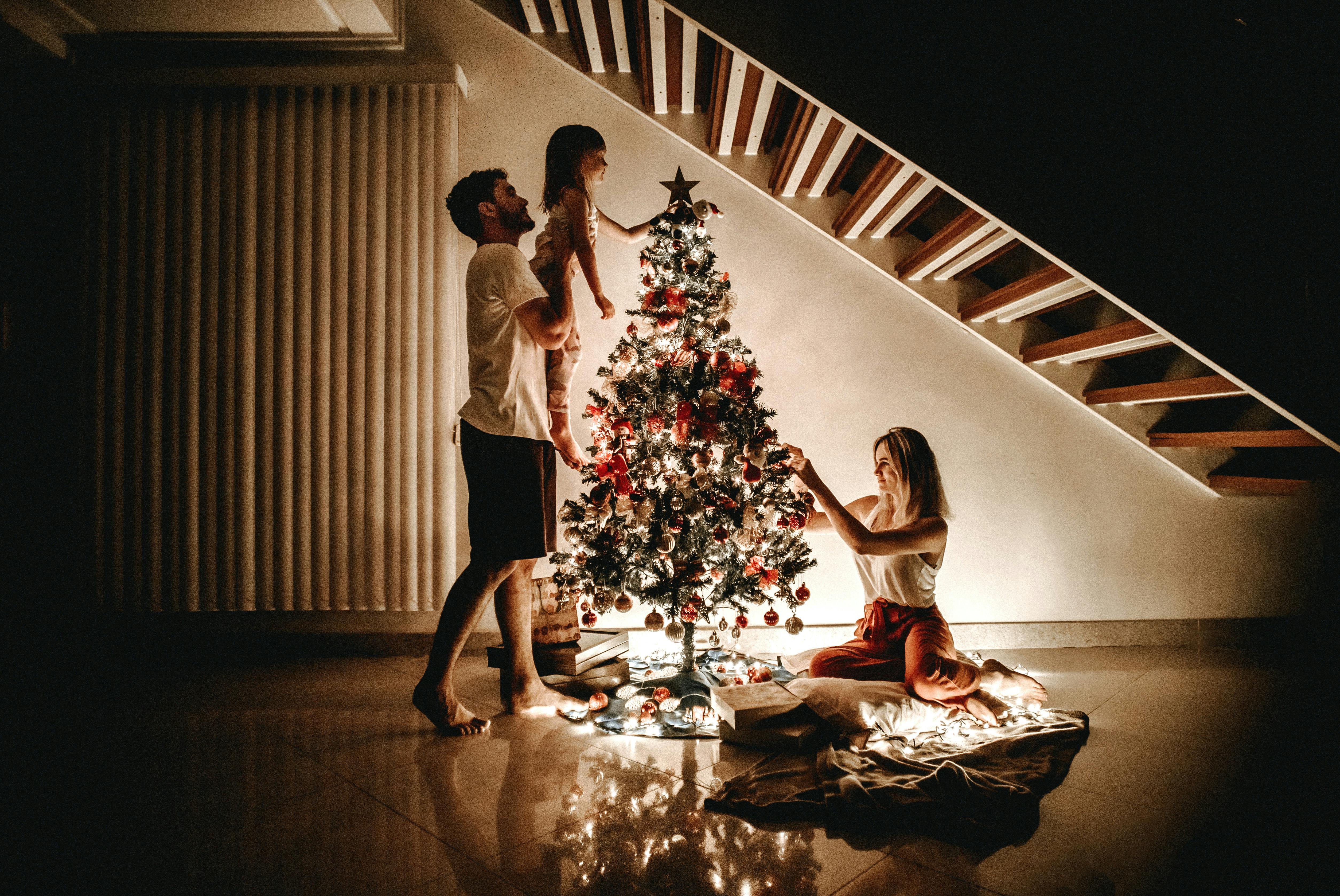 Family Decorating Christmas Tree at Home 