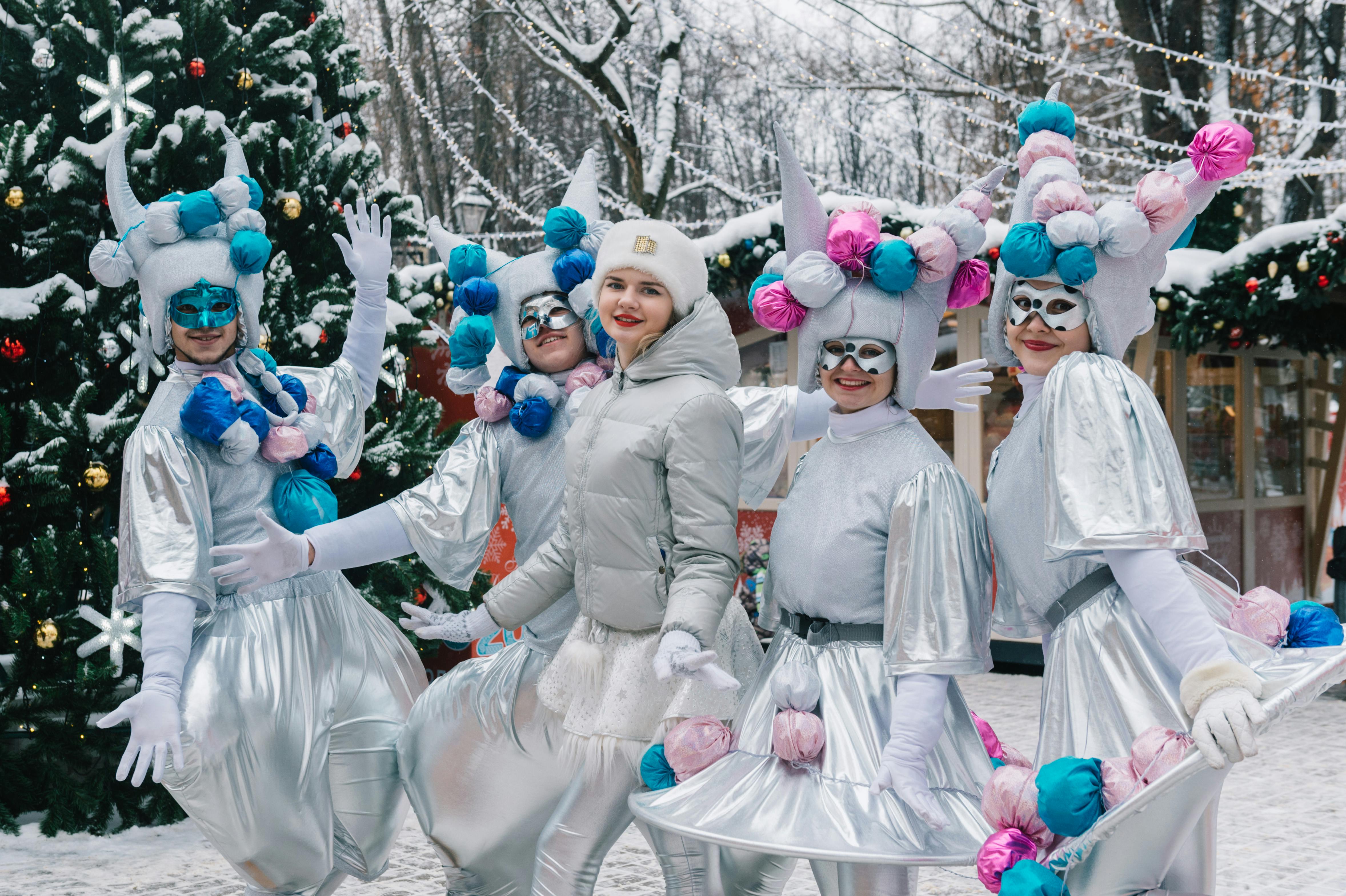 Festive Winter Street Performers in Silver Costumes