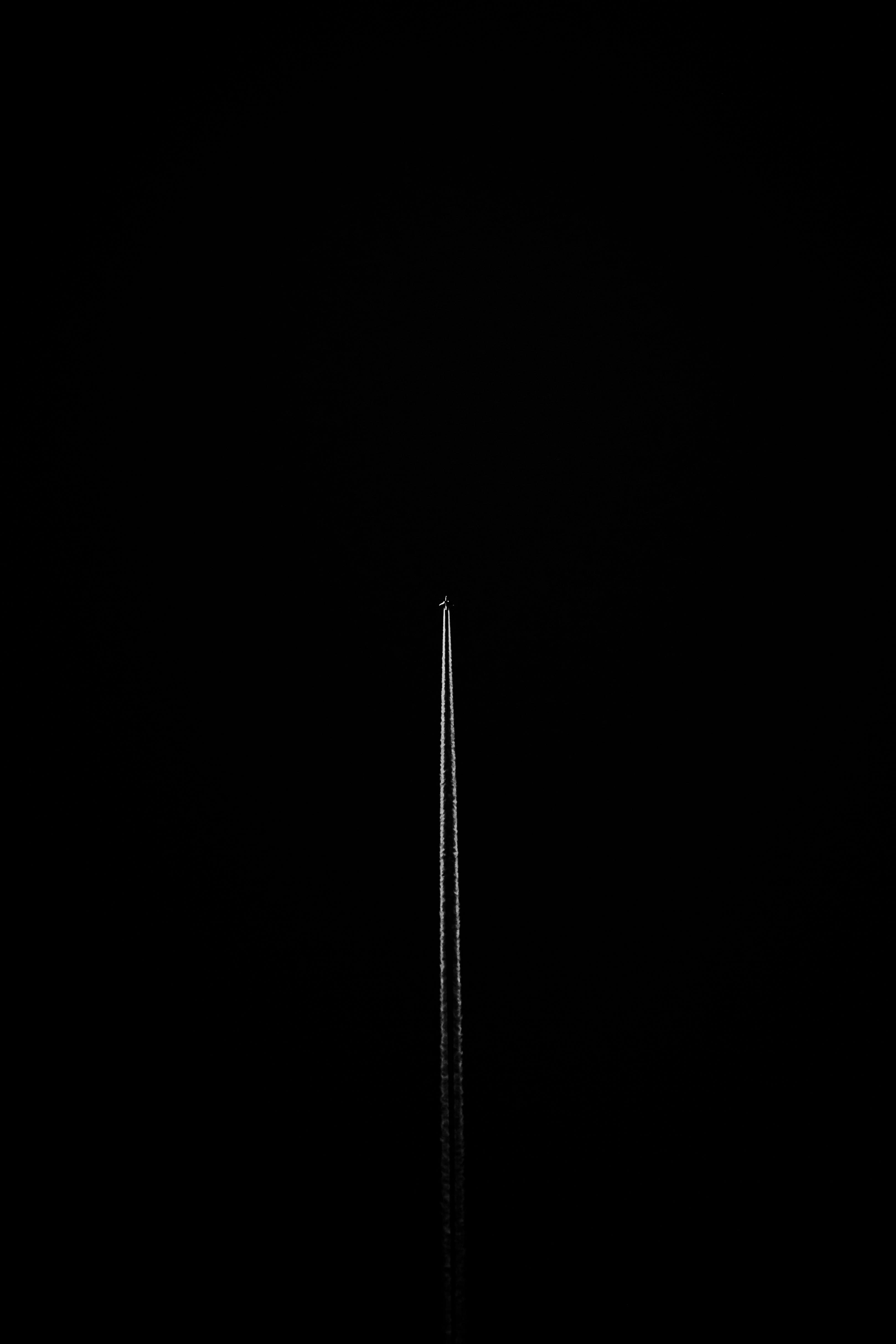 Minimalist Airplane Contrail in Black Sky