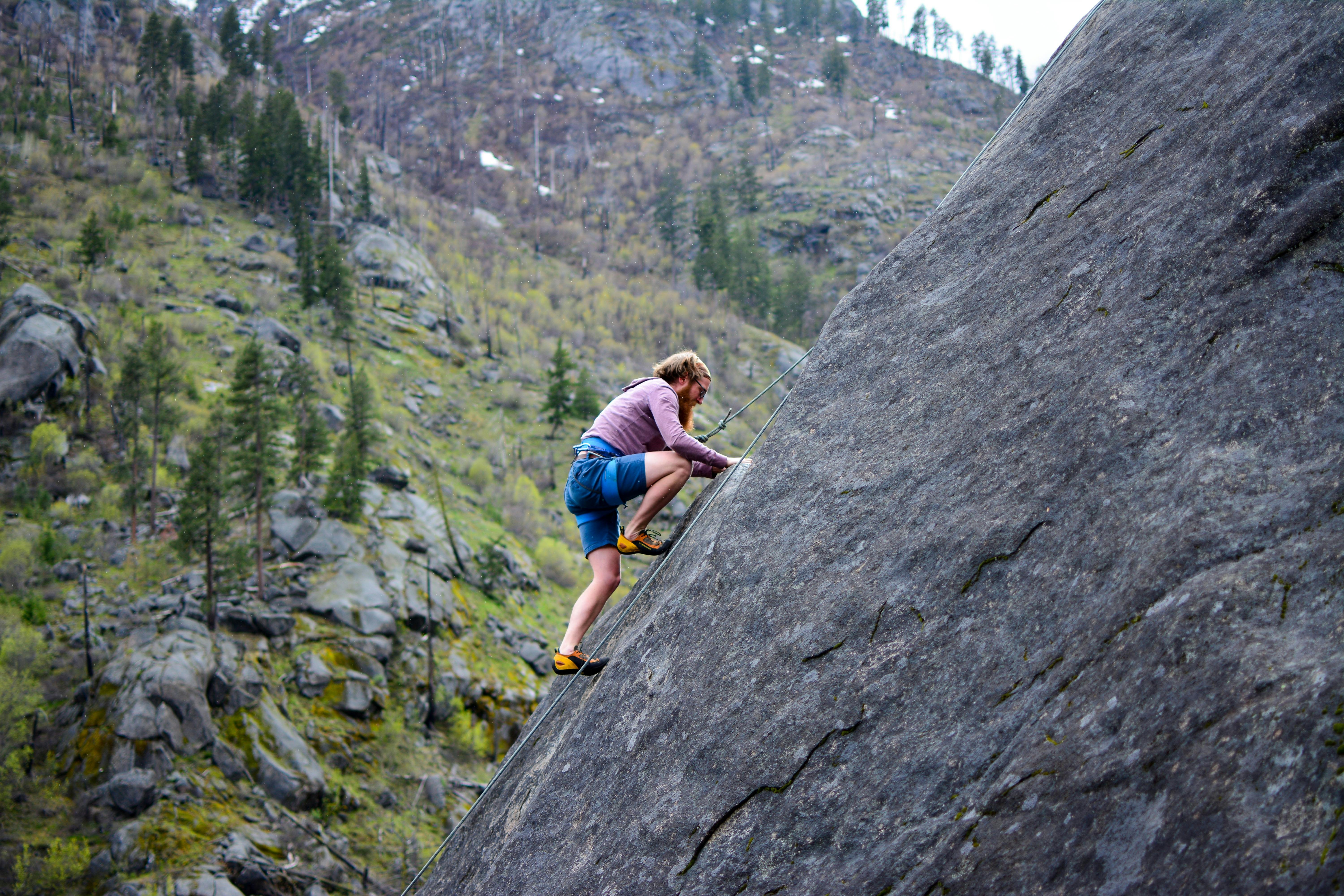 Rock Climber on Steep Mountain Face