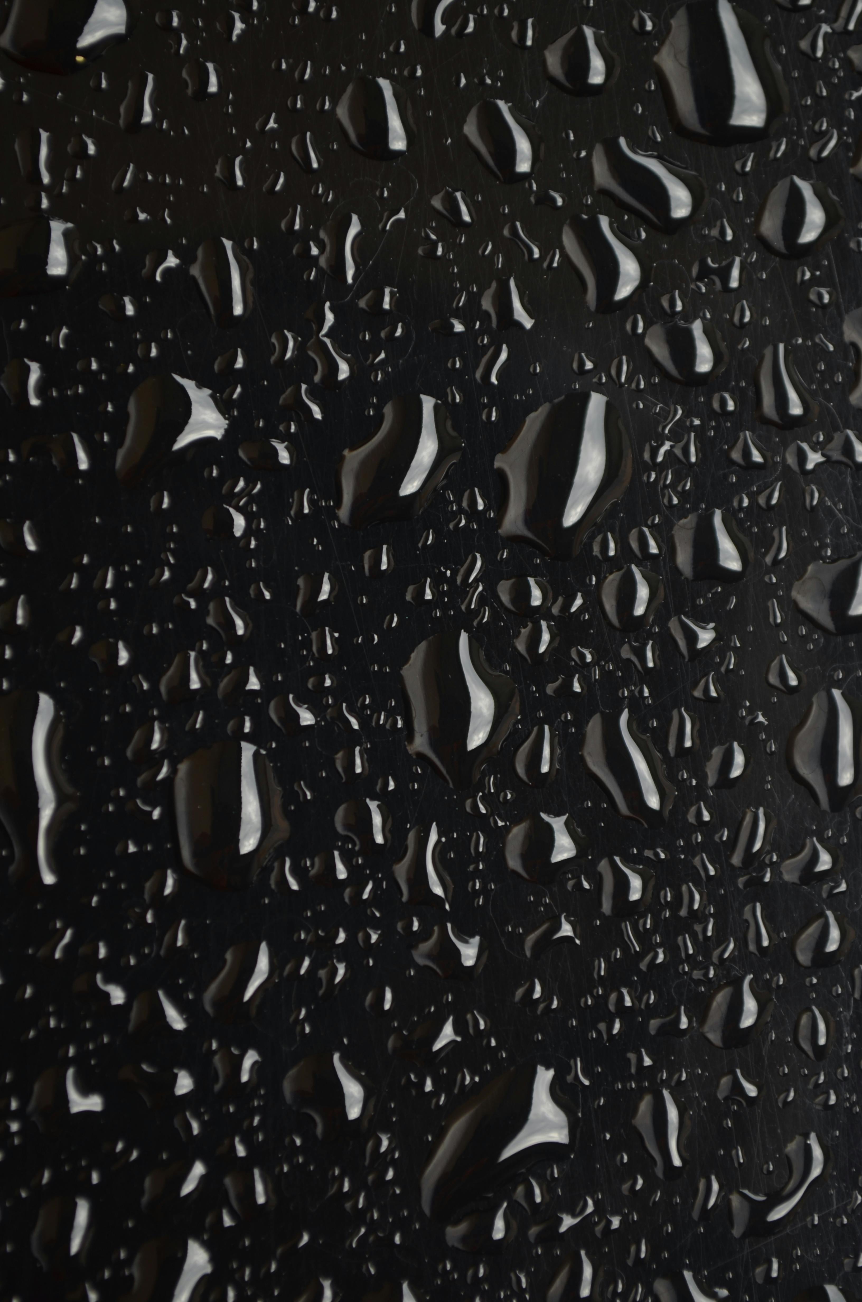 Stunning Water Droplets on a Black Surface 